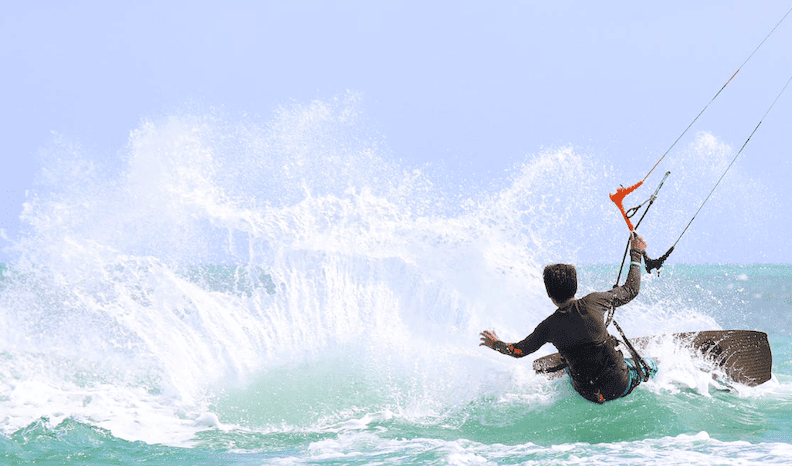 Young person wakeboarding on a sunny day.